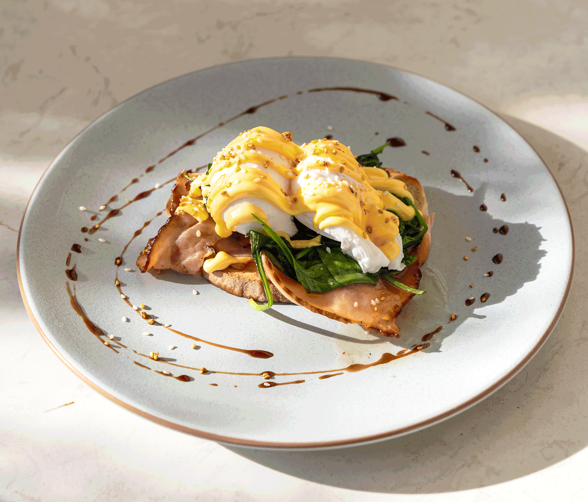 Rotating image of multiple breakfast items such as Eggs Benedict & Breakfast Burger