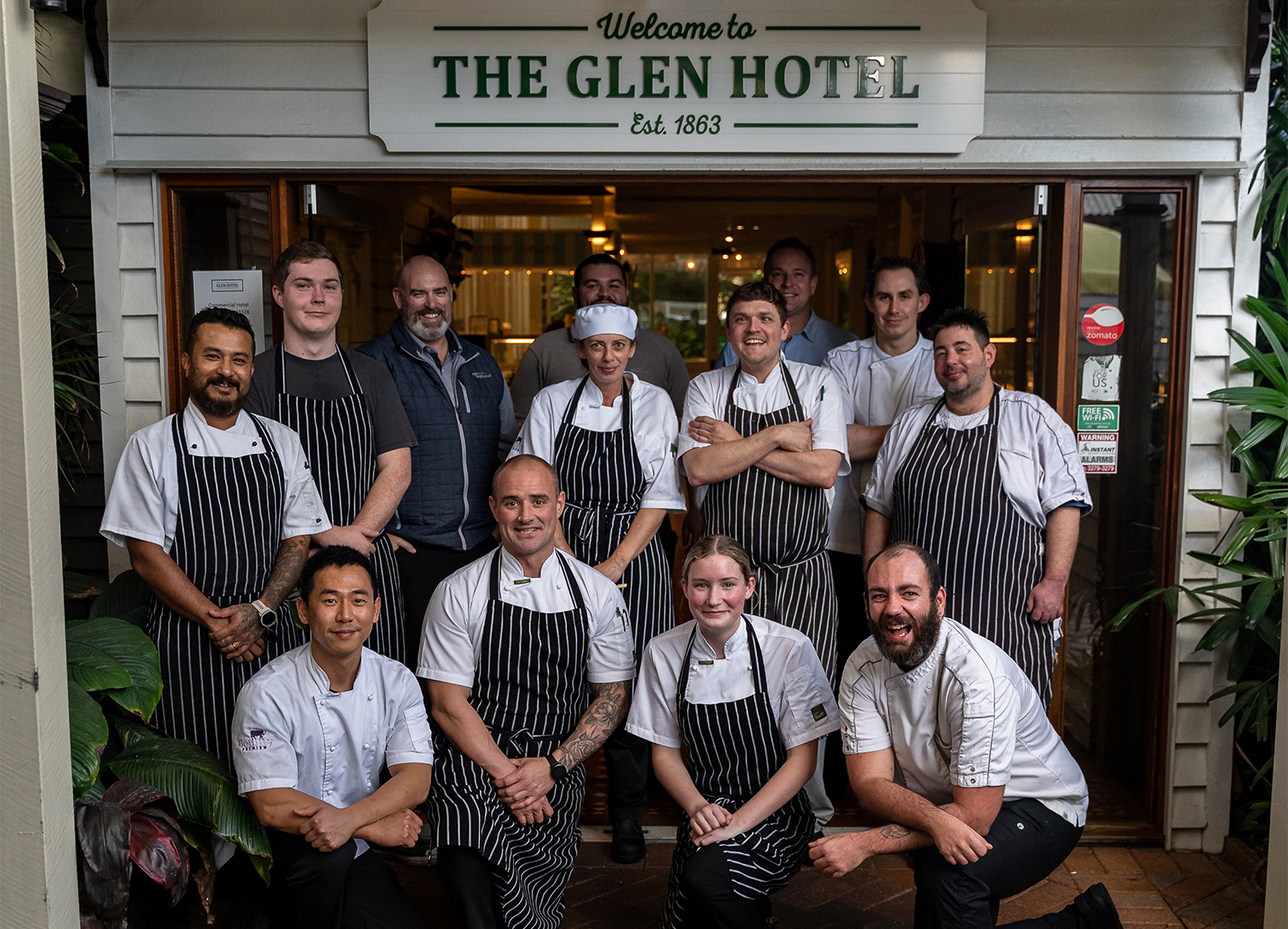 Brad Casey and his team of dedicated chef's and passionate suppliers posed at the entrance to The Glen Hotel