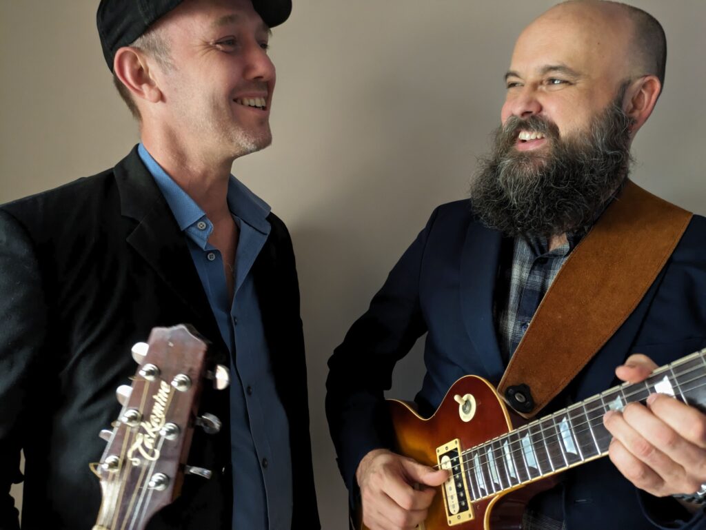 Ben Stewart and bandmate holding guitars